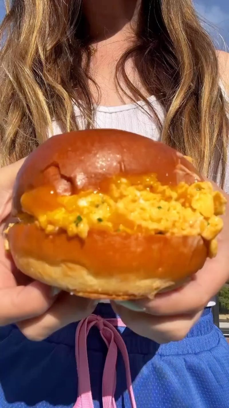 California – Brioche Bun Stacked with Scrambled Eggs, Avocado, and Sriracha Mayo